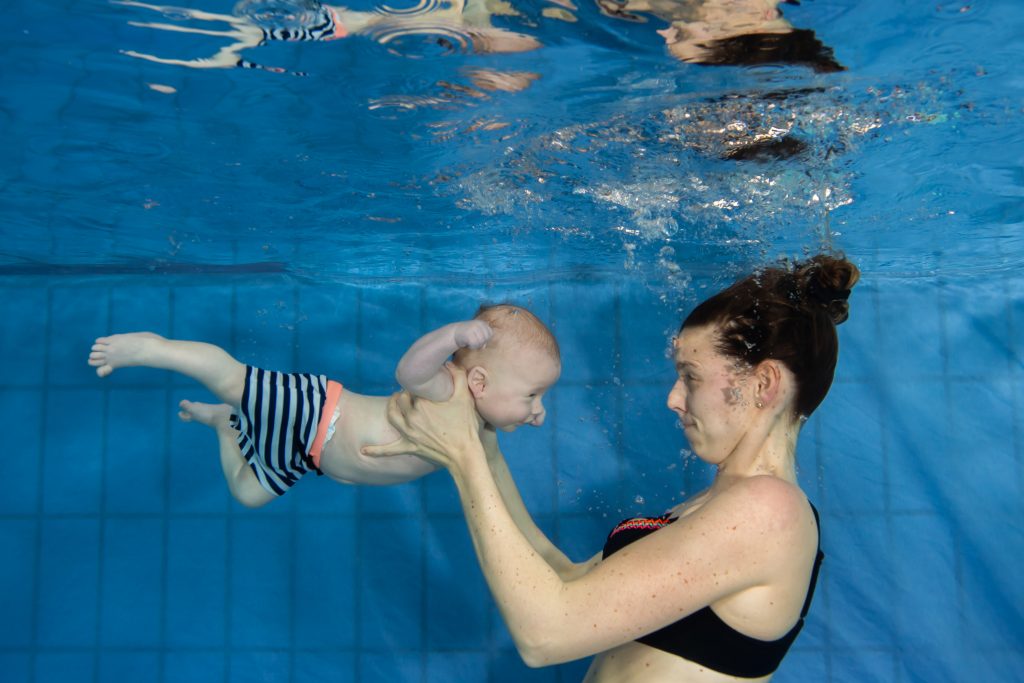 Mama met baby onderwater