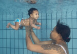 Mama met baby onderwater